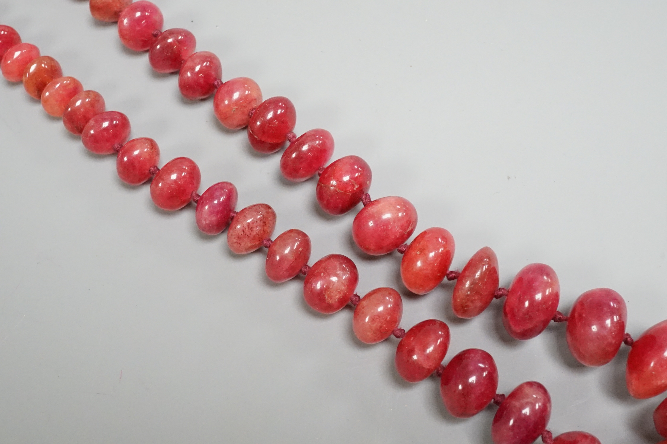 A modern single strand graduated polished ruby pebble necklace, with 585 yellow metal clasp, 54cm.